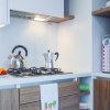 Cucina moderna con teiere e moka su fornelli a gas.
