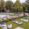 Spazio relax con sedie e tavoli vicino piscina.