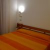 Camera da letto con letto matrimoniale arancione e due lampade a parete.
