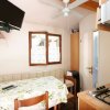 Interno con tavolo, TV e cucina.